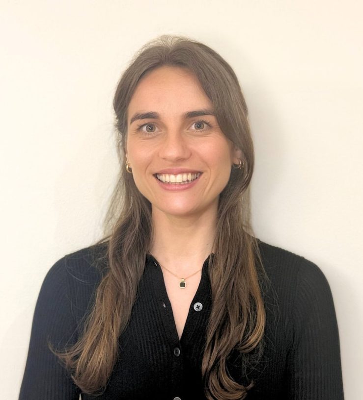 A photo of Amy Buckley, who has long, dark brown hair, she is smiling