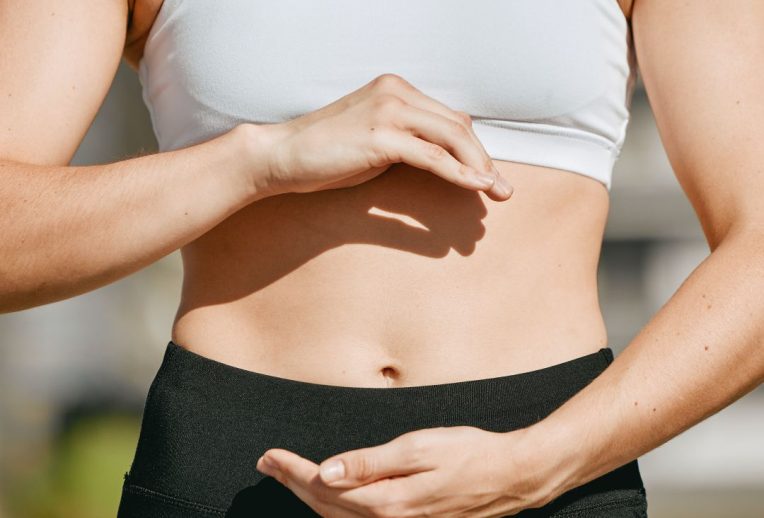 Dr Megan Rossi in a lab looking through a microscope