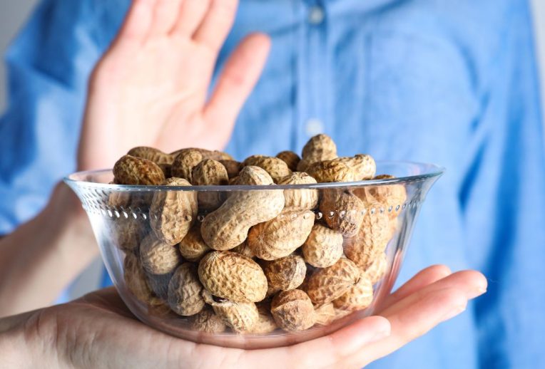 Dr Megan Rossi in a lab looking through a microscope