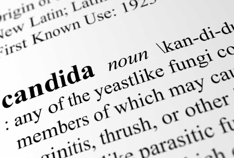 Dr Megan Rossi in a lab looking through a microscope