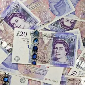 Several £20 notes laid out on a table