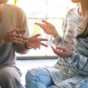 A photo of two people talking