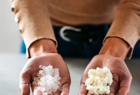 Two hand palms up holding fermented dairy and water kefir
