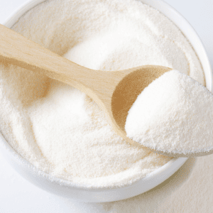 Photo of white prebiotic powder in a white bowl on a white surface